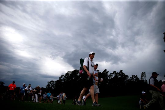 Customers head to the exits while a weather warning sounds during the second round of the 2019 Masters tournament to be held at the Augusta National Golf Club in Augusta, Georgia. On April 12, forecasters warn that a new wave of storms could hit the tournament Sunday in the final hours.