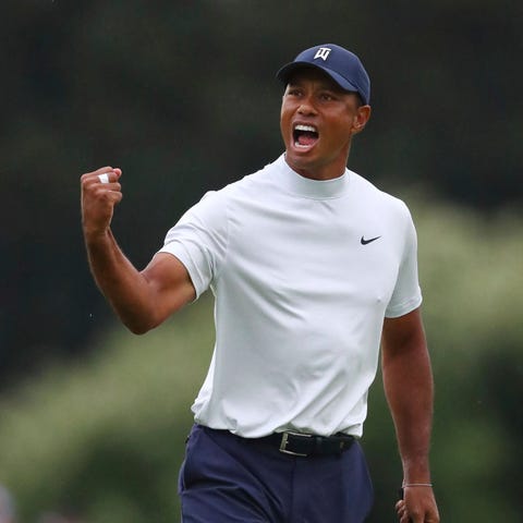 Tiger Woods reacts to his birdie putt on 15...