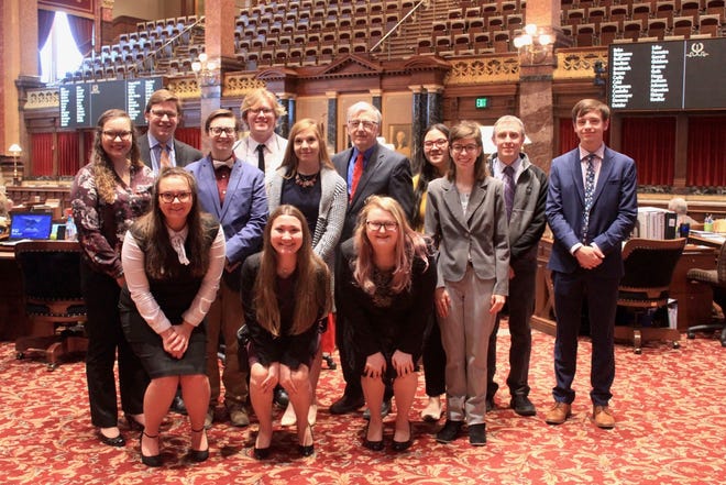 Members of the Simpson College national champion debate team met with state Sen. Julian Garrett in the Iowa Senate chamber. They were recognized in the Senate for their accomplishment on April 9. Simpson has won the national championship three of the last four years.