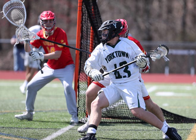 Yorktown's Alex DeBenedictis (43) tries to get a shot off against Chaminade during boys lacrosse action at Yorktown High School April 13,  2019. Chaminade won the game 11-5.