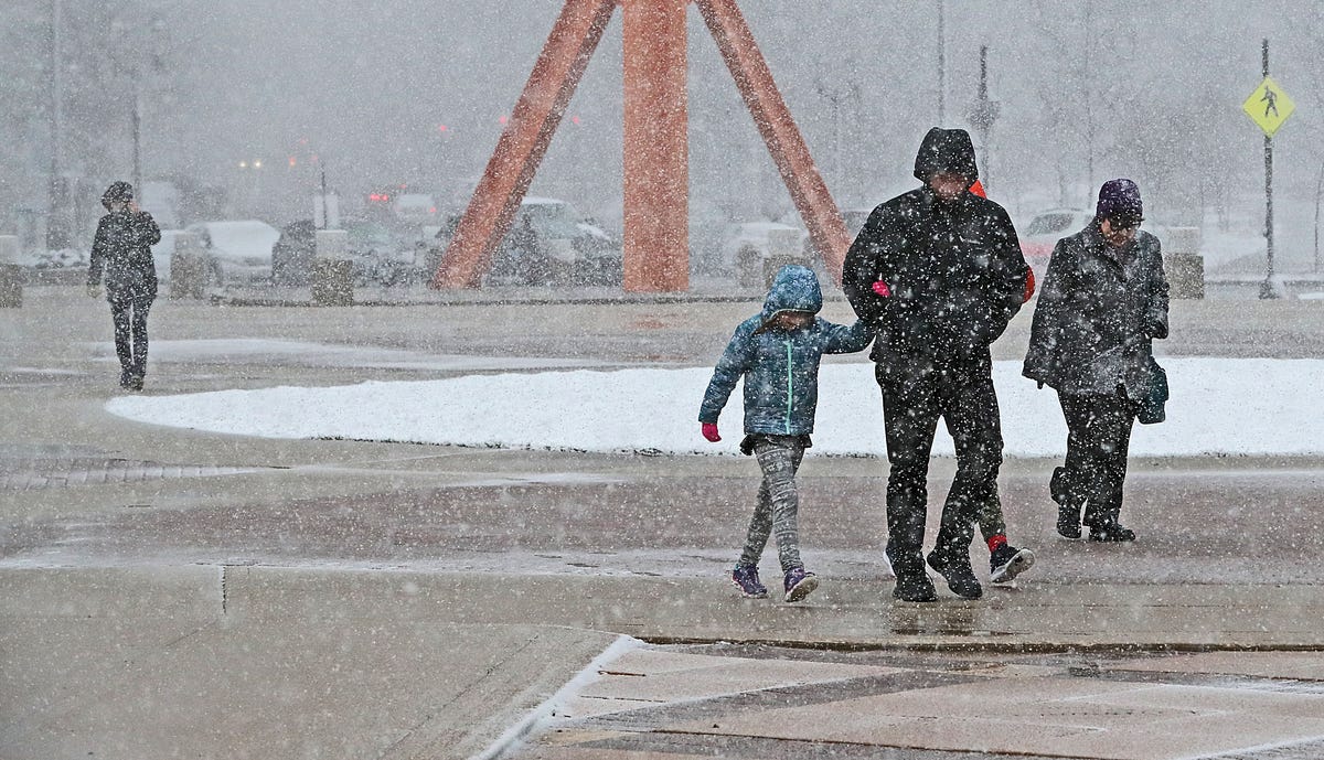 Gusty winds and wet snow greeted visitors to Milwaukee's lakefront as they walked past the steel sculpture 