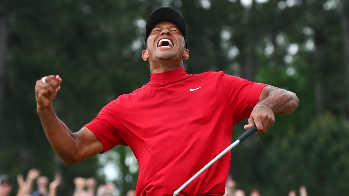 Tiger Woods celebrates after making a putt on the 18th green to win The Masters.