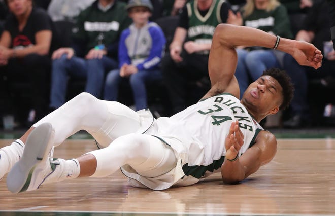 Bucks forward Giannis Antetokounmpo hits the court after being fouled in Game 1 of the NBA playoff series against the Pistons Sunday. If you don't have courtside seats, you can still catch the action on TV and radio.