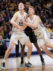 Marquette forward Joey Hauser (22) and Marquette forward Sam Hauser (10) box out Providence guard Alpha Diallo (11) during a free throw attempt during the second half of their 79-68 win over Providence at Fiserv Forum.