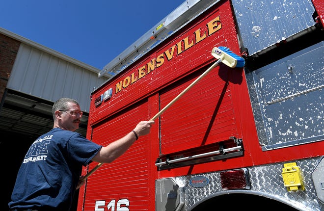 Nolensville Volunteer Fire Department member Daron Standifird washes the department's firetruck between calls on Monday, April 15, 2019.