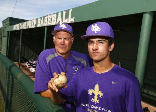 Notre Dame Prep sophomore Brady Fischer poses for a portrait with his father and varsity baseball coach Brian Fischer at Notre Dame Prep Baseball Field in Scottsdale, Ariz. on April 8, 2019.