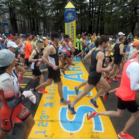 Runners cross the start line of the 123rd Boston M