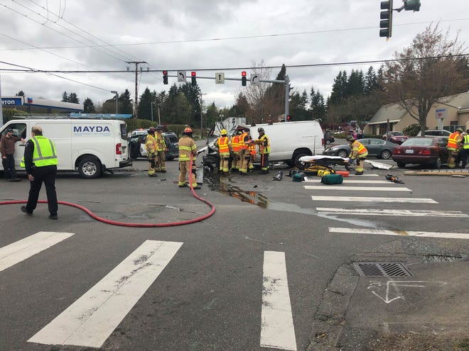 Firefighters respond to a crash at Highway 303 and Riddell in East Bremerton on Tuesday.