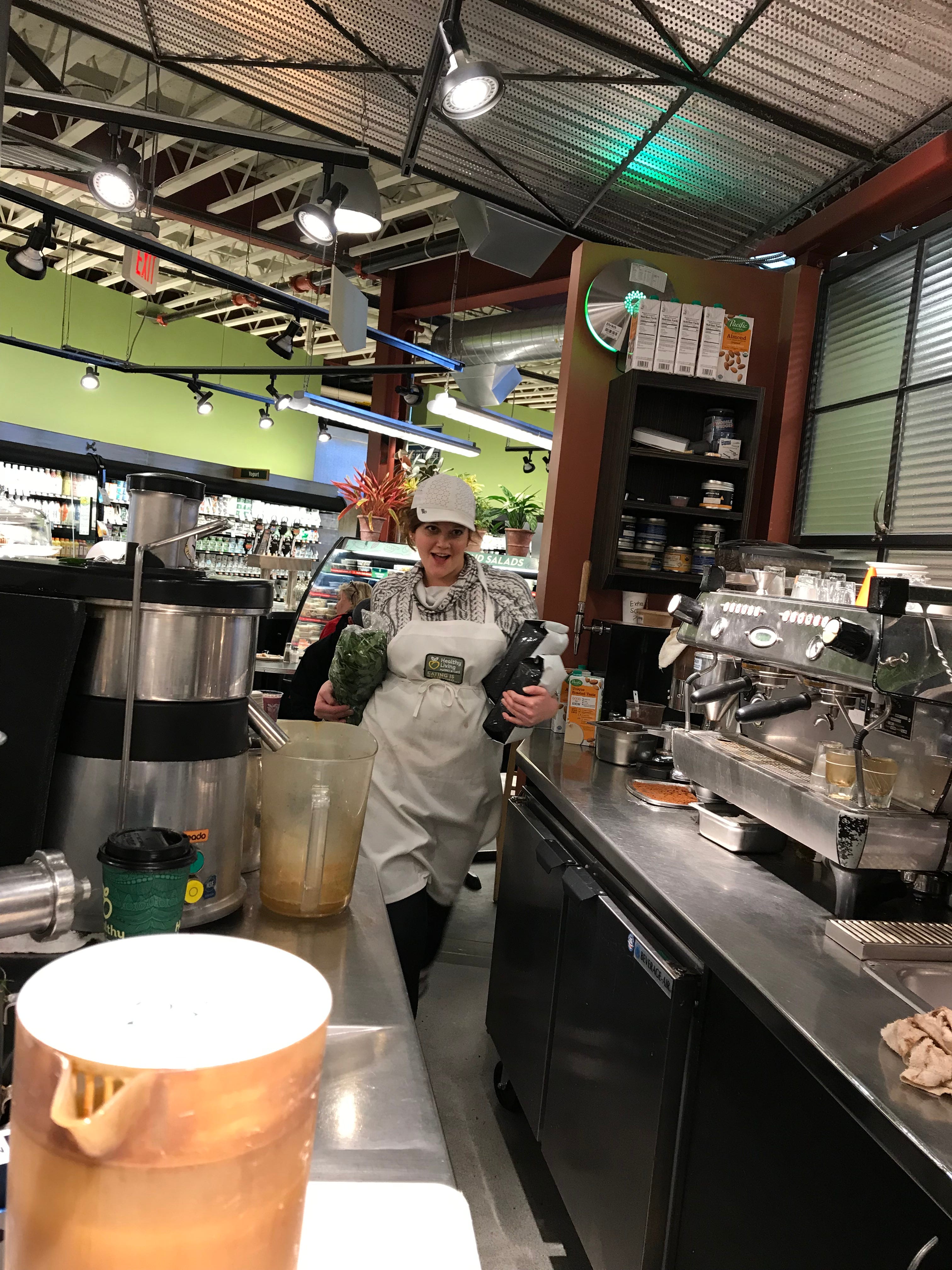 Melissa Cohen does a little dance while walking behind the barista bar at Healthy Living Market & Cafe on April 3, 2019. She's almost finished with her shift, which ends at 2 p.m.
