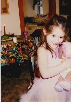 Jeanina Messerly plays with her doll as a child.