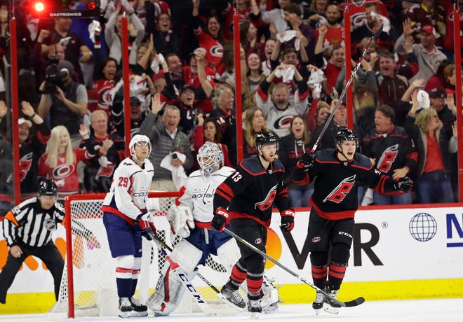 Hurricanes' Warren Foegele (13) and Brock McGinn celebrate Foegele's goal against the Capitals during the first period of Game 3 on Monday.