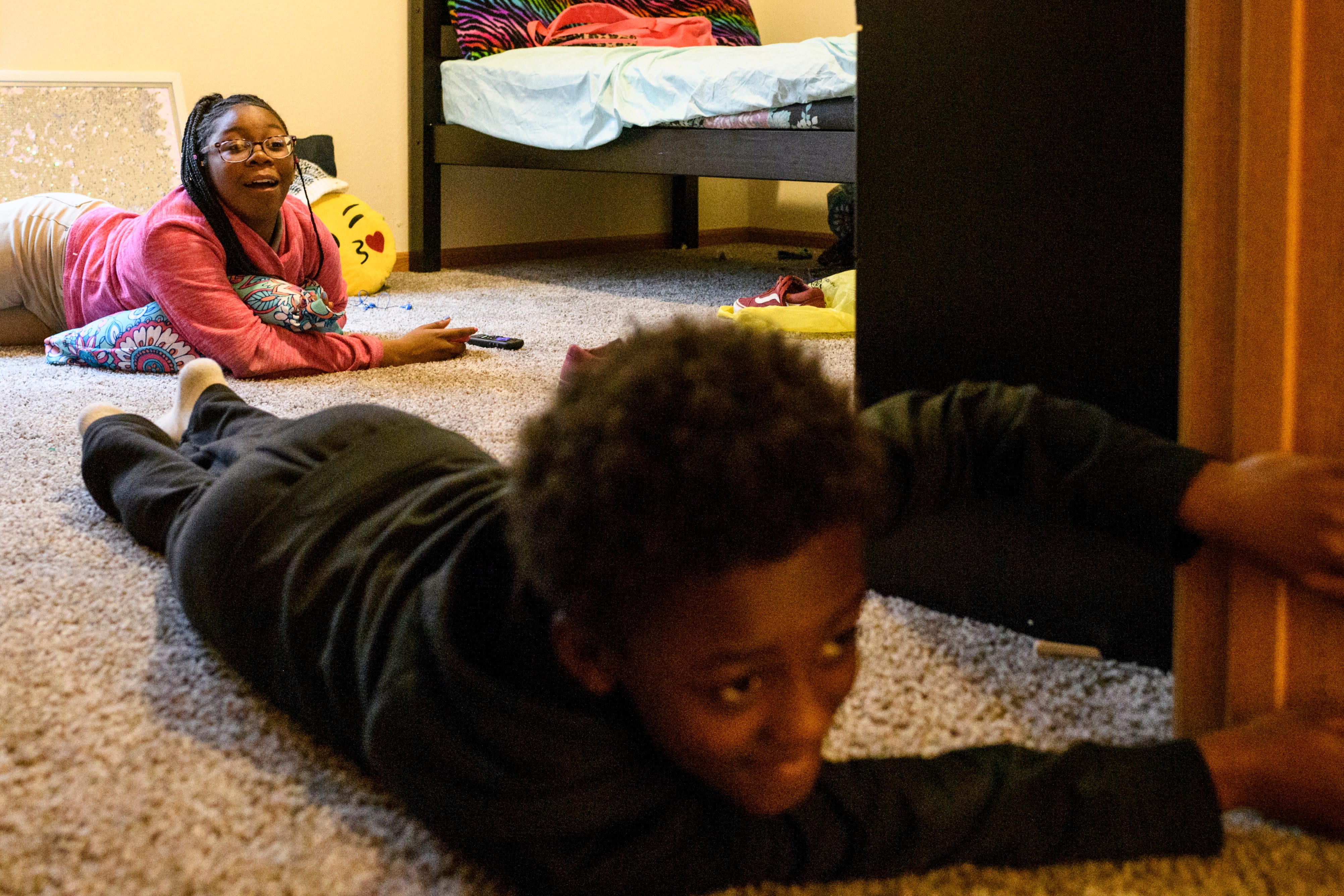 "Get out of my room," Aliyah says as she reacts to her younger siblings Travon, front, and Teresa, not pictured, continually popping in and out of her new room while burning off their energy during playtime, Thursday evening, March 21, 2019. For the first several weeks there was an ample amount of space to run around as the family waited for the delivery of big furniture items, such as a couch and a dining room table. 