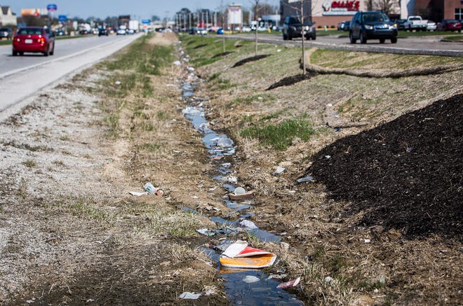 Litter collects in the ditch along McGalliard Road in front of Walmart and Lowe's in Muncie.