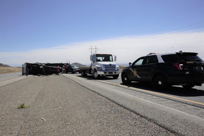 A pickup truck pulling a travel trailer heading eastbound on US Highway 70 overturned about 10:11 a.m. Tuesday, April 16, 2019, police said.