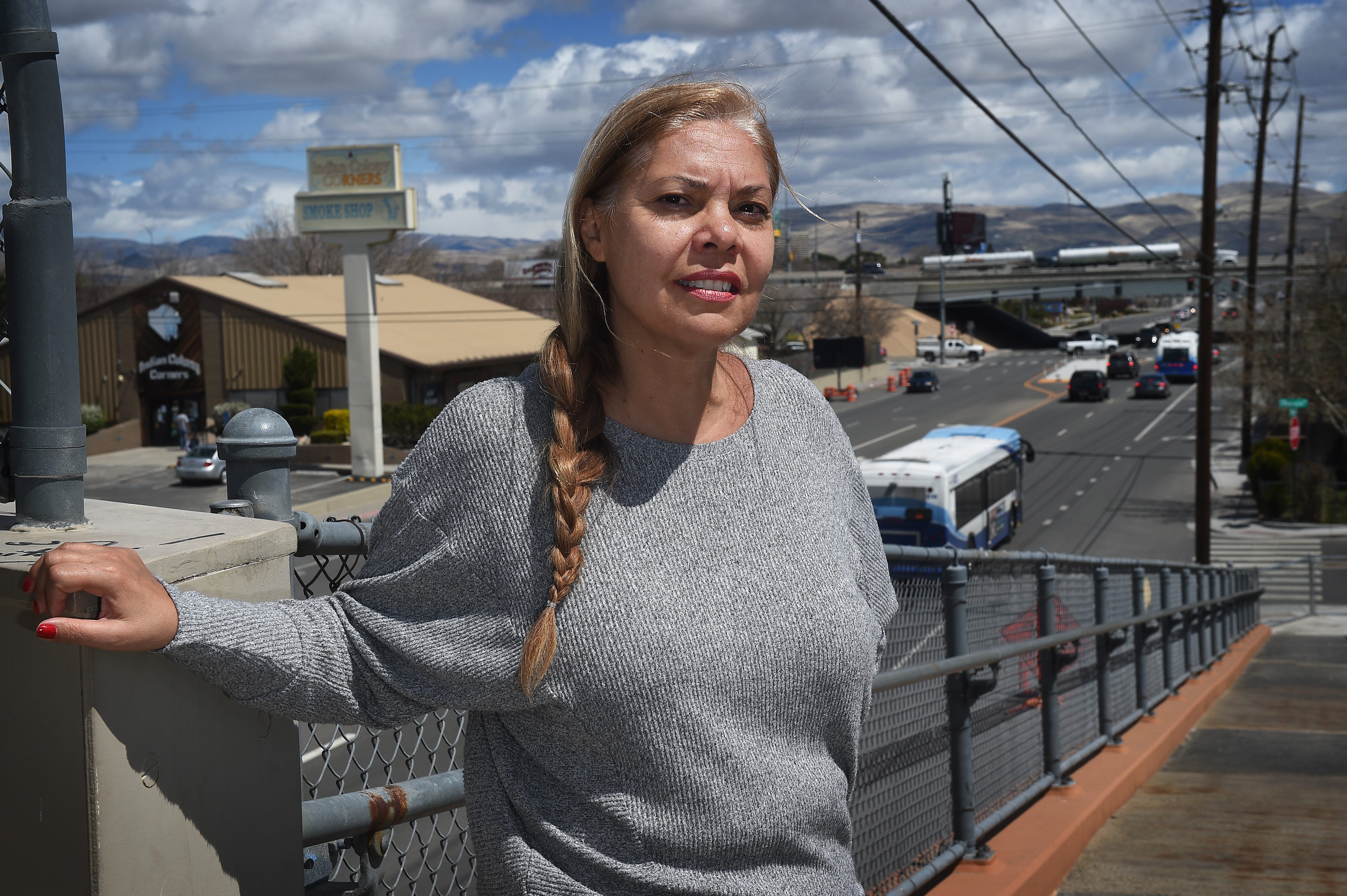 Stacey Montooth poses for a portrait on a pedestrian bridge over 2nd Street in Reno on April 16, 2019.
