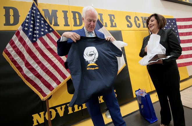 U.S. Sen. John Cornyn, R-Texas, opens a gift honoring UTEP President Diana Natalicio after holding a pair of roundtables with students and educators at Parkland Middle School on Tuesday, April 16, 2019. Cornyn visited the school to learn about the impact of the Gear Up program on students. Cornyn is working on a bipartisan bill, The Gear Up for Success Act, which will make improvements to the existing program. Currently, the bill requires school districts to match grant dollars, which Cornyn said can be burdensome on their budgets. He hopes to reduce the percentage of matching dollars from 100% to 50% to make it more accessible to schools. The Gear Up Program, among other things, pairs middle school students with UTEP students who act as educational mentors.