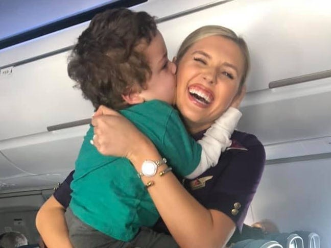 Delta flight attendant Amanda Amburgy receives a hug and kiss from Xayvior Johnson.