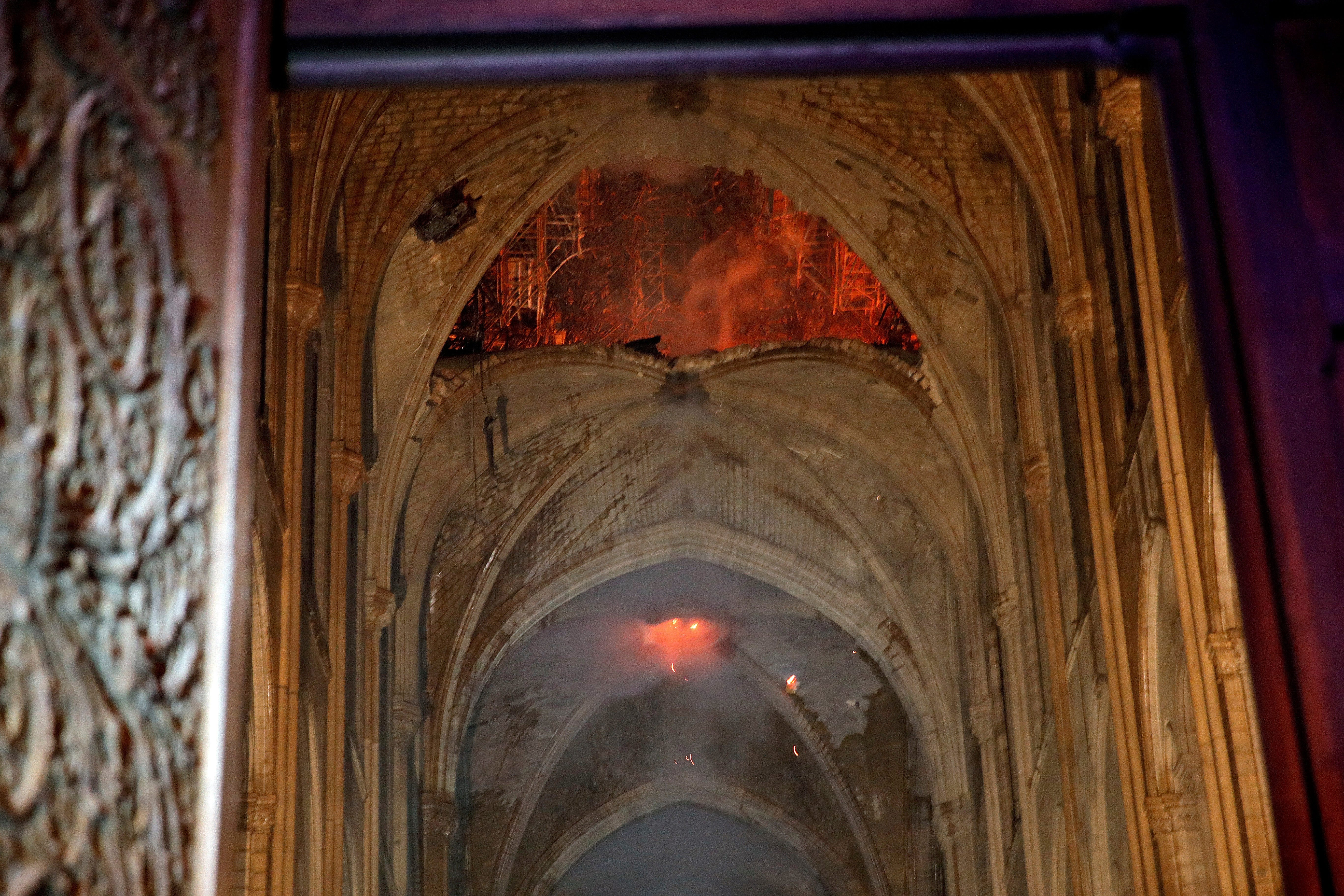 Flames and smoke are seen as the interior at Notre Dame cathedral in Paris, Monday, April 15, 2019. A catastrophic fire engulfed the upper reaches of Paris' soaring Notre Dame Cathedral as it was undergoing renovations Monday, threatening one of the greatest architectural treasures of the Western world as tourists and Parisians looked on aghast from the streets below.