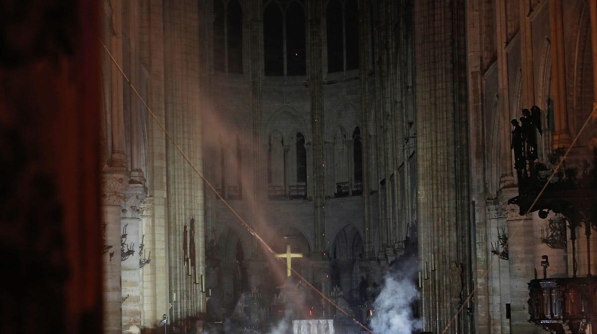 Smoke is seen in the interior of Notre Dame cathedral in Paris, Monday, April 15, 2019. A catastrophic fire engulfed the upper reaches of Paris' soaring Notre Dame Cathedral as it was undergoing renovations Monday, threatening one of the greatest architectural treasures of the Western world as tourists and Parisians looked on aghast from the streets below. PAR166