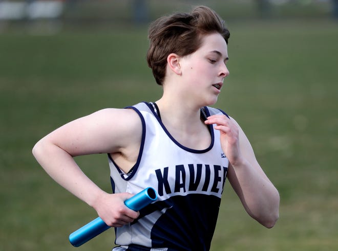 Xavier's Madeleine McDermott competes in the 3,200-meter relay during the Bay Conference Relays track and field meet Tuesday at Xavier.