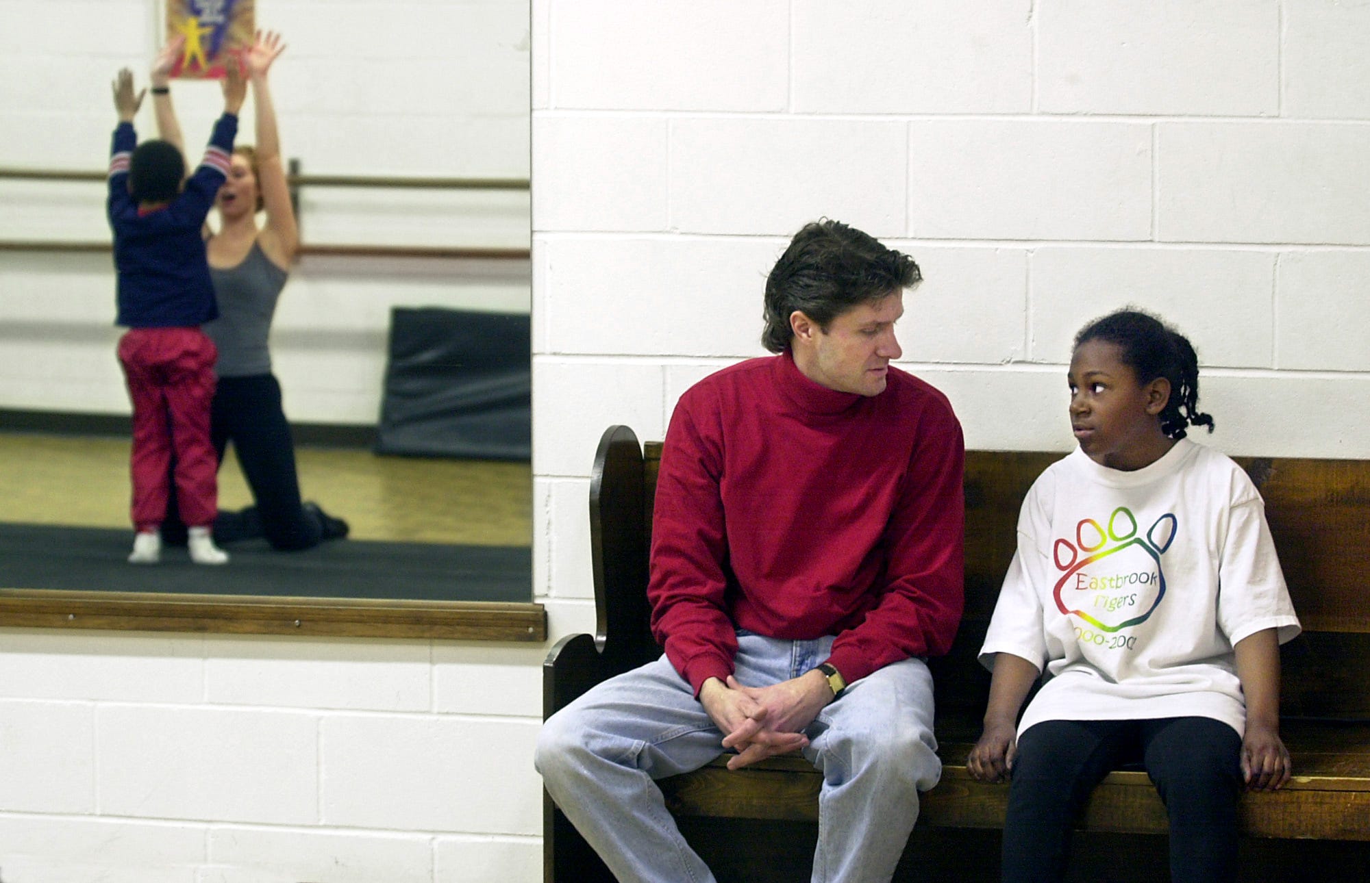 Ashley and her adoptive father Craig Peterson chat during a break in a dance class.