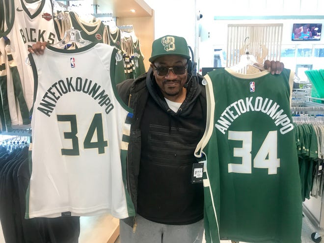Julius Cocroft buys jerseys for his uncles who live in Chicago at the Bucks Pro Shop at Fiserv Forum.