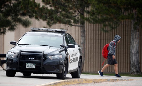 A student leaves Columbine High School on April 16, 2019, in Littleton, Colorado.