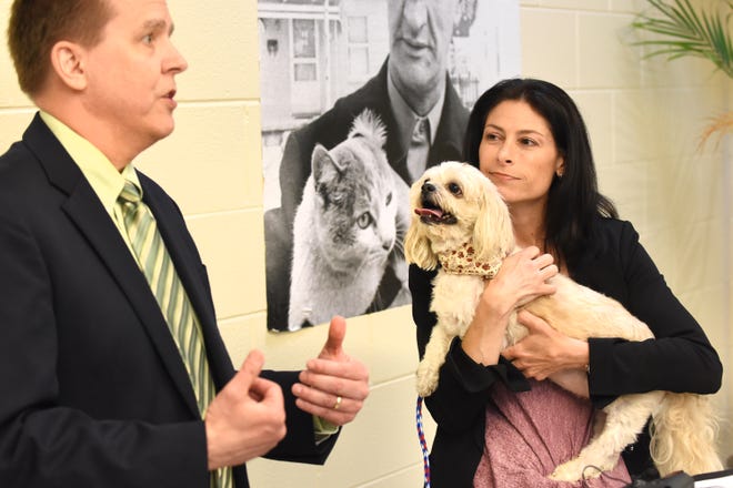 Michigan Attorney General Dana Nessel holds Gucci, a 10-year-old Shi Tzu, as she listens to Consumer Protection Bureau Chief Joseph Potchen speak about the importance of recognizing and stopping puppy scams in the state.