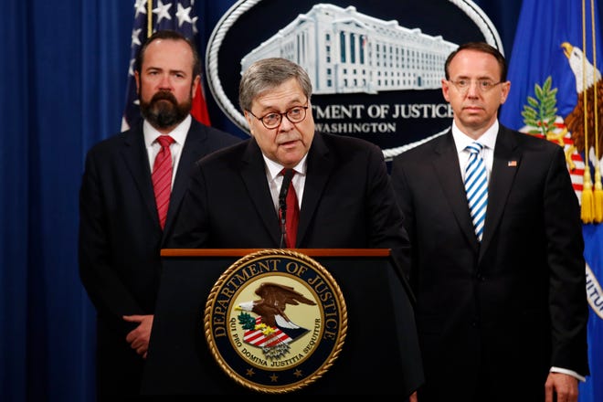 Attorney General William Barr speaks alongside Deputy Attorney General Rod Rosenstein, right, and Deputy Attorney General Ed O'Callaghan, left, about the release of a redacted version of special counsel Robert Mueller's report during a news conference, Thursday, April 18, 2019.
