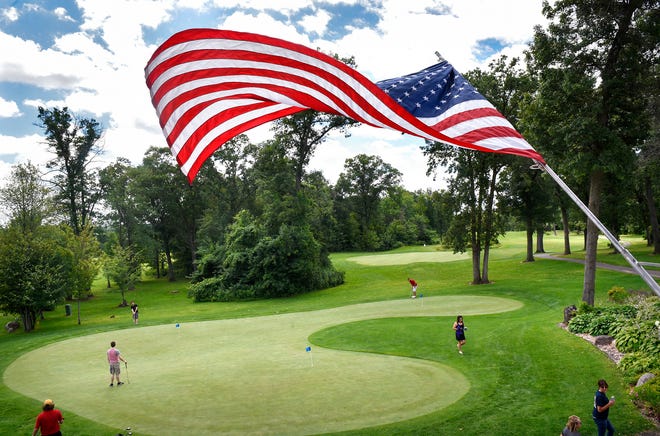 The American flag waves gracefully over the practice green at Blackberry Ridge Golf Course & Event Center in Sartell.