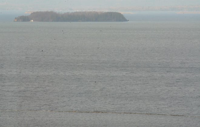 The waters of Lake Champlain nearly cover the breakwater along Burlington Bay seen in the foreground on Friday, April 19, 2019.