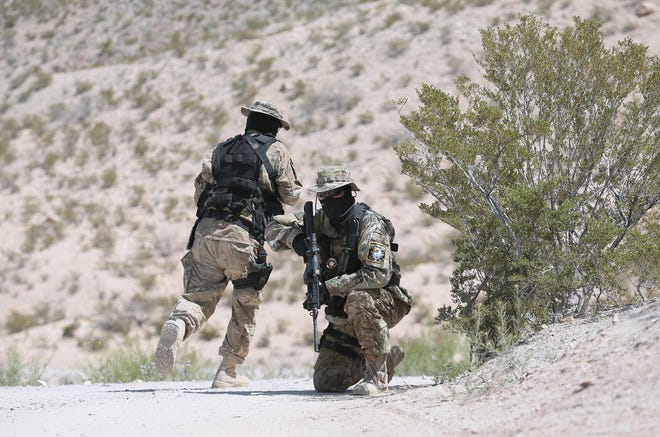 "Viper" and "Stinger," of the United Constitutional Patriots-New Mexico Border Ops, patrol where the bollard fence in Anapra, N.M., ends. The group has been camped out on the border for a few months. Members say they are helping the Border Patrol.