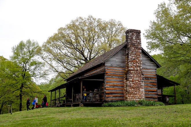A family walks up the hills alongside an old preserved building at the annual Easter egg hunts at Historic Collinsville in Clarksville, Tenn., on Saturday, April 20, 2019. 
