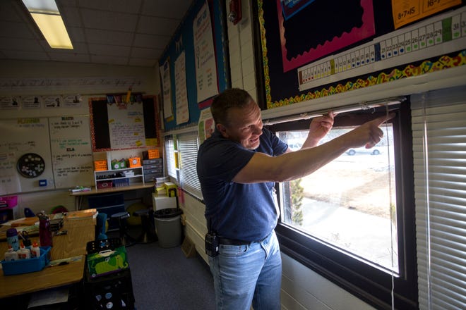 Country Club Elementary School Principal Shannon Waller points out the problems with one of the his classroom's windows on Friday, Jan. 12, 2018 at Country Club Elementary School in Farmington.