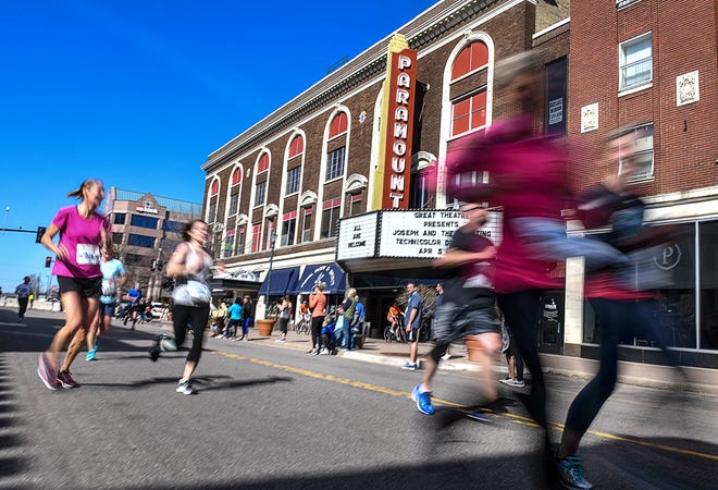Runners speed past the Paramount Theatre on St. Germain Street during the Cetera Half Marathon as part of CentraCare Health Earth Day Run activities Saturday, April 20, in downtown St. Cloud.