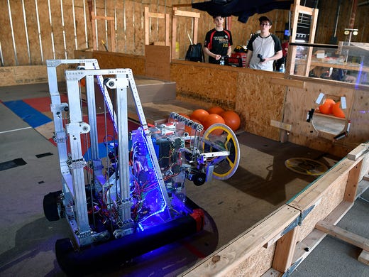 Bryce Neptune, left, and Jagr Krtanjeck, both 18, of the  Tech Fire robotics team practice running the robot for the upcoming World Championship event in Detroit, Thursday, April 18, 2019.John A. Pavoncello photo