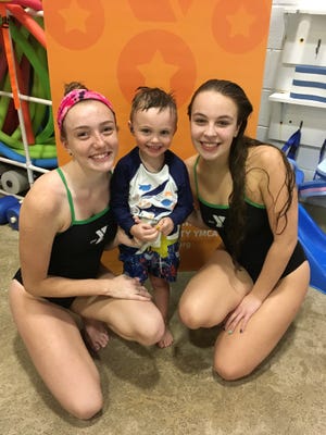 Y swim instructors with a student.