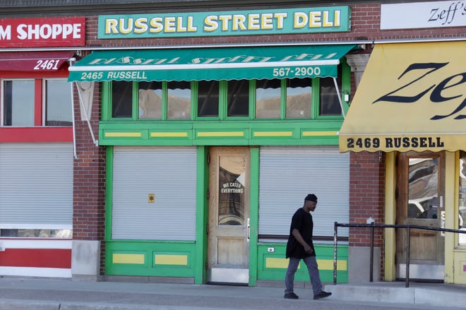 A man walks past Russell Street Deli in Eastern Market on Monday, April 22, 2019.