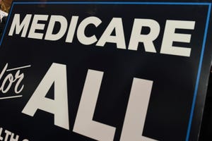 In this April 10, 2019 file photo, a sign is shown during a news conference to reintroduce  "Medicare for All" legislation, on Capitol Hill in Washington.