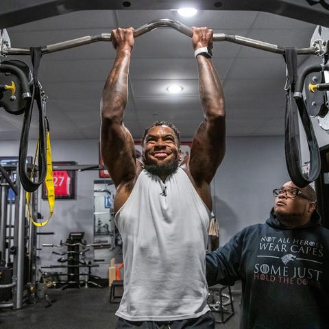 Justin Brent (left) does reverse pull-ups...