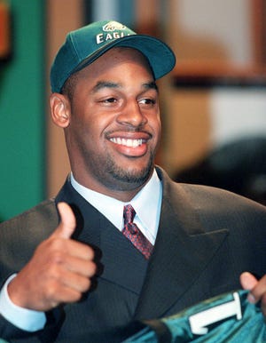 Former Syracuse quarterback Donovan McNabb gives a thumbs up as he poses for the media after the Philadelphia Eagles made him team's first pick, second overall, in the NFL Draft April 17, 1999 in New York.