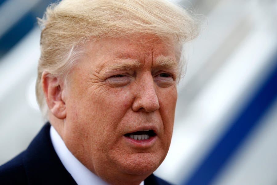 President Donald Trump takes questions from a gathering of reporters next to Air Force One at Lunken Airport in Cincinnati on Friday, Oct. 12, 2018.