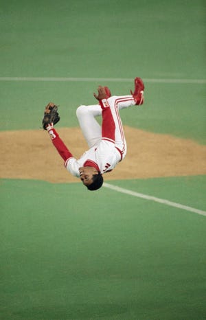 Cincinnati Reds shortstop Barry Larkin does a flip after they defeated the Pittsburgh Pirates 2-1 at Riverfront Stadium to win the NLCS, Friday, Oct. 13, 1990, Cincinnati, Oh.