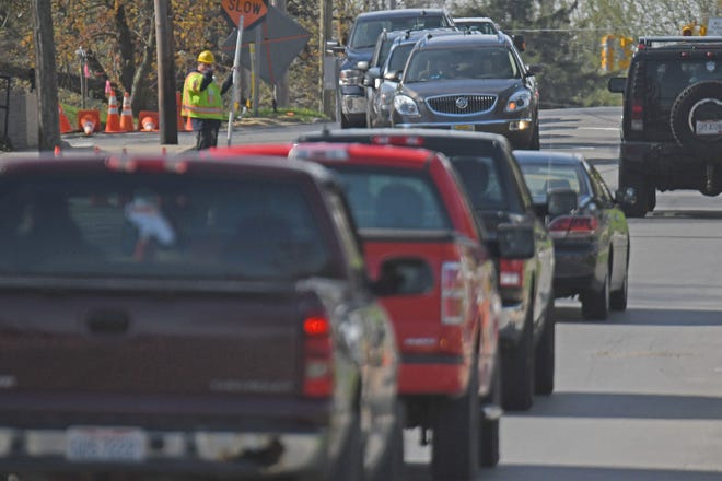 Flaggers control traffic flow Wednesday morning on South Main Street near Cameron Avenue.