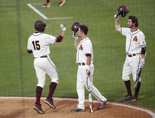 ASU's Erik Tolman (15) is congratulated after hitting a solo home run against UNLV during the second inning in Phoenix April 23, 2019.