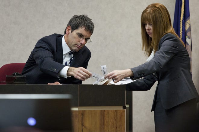 Mary Kelly, right, then-working as an assistant prosecuting attorney, look over evidence bags during a trial in 2015 in the courtroom of Judge Cynthia Lane. Kelly was recently named to the guardian ad litem position in St. Clair County, the contract for which was voted down by county commissioners during a board meeting April 18, 2019.