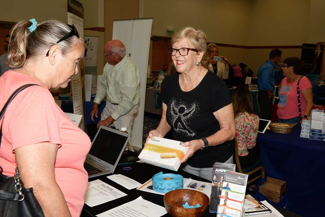 Debbie Becker, left, learns about Isagenix from Anne Mygatt at the Treasure Coast Healthcare Summit April 13 at the Port St. Lucie Civic Center.