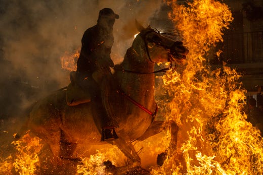 SAN BARTOLOME DE PINARES, SPAIN - JANUARY 16: A man rides a horse through a bonfire during 'Las Luminarias' Festival on January 16, 2019 in San Bartolome de Pinares, in Avila province, Spain. In honor of Saint Anthony the Abbot, the patron saint of animals, horses are ridden through the bonfires on the night before the official day of honoring animals in Spain. The tradition, which is hundreds of years old, is meant to purify and protect the animal in the coming year. (Photo by Pablo Blazquez Dominguez/Getty Images) ***BESTPIX*** ORG XMIT: 775282996 ORIG FILE ID: 1095187618