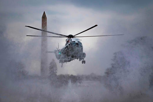 Marine One kicks up snow as it lands on the South Lawn of the White House in Washington, DC, on Feb. 1, 2019.