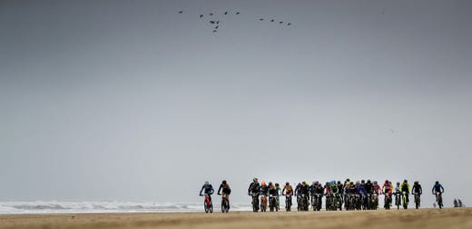 TOPSHOT - Contesters ride on the beach during the Egmond-Pier-Egmond cycling race in Egmond aan Zee, The Netherlands, on January 12, 2019. (Photo by Robin van Lonkhuijsen / ANP / AFP) / Netherlands OUTROBIN VAN LONKHUIJSEN/AFP/Getty Images ORG XMIT: 68475204 ORIG FILE ID: AFP_1C63BH